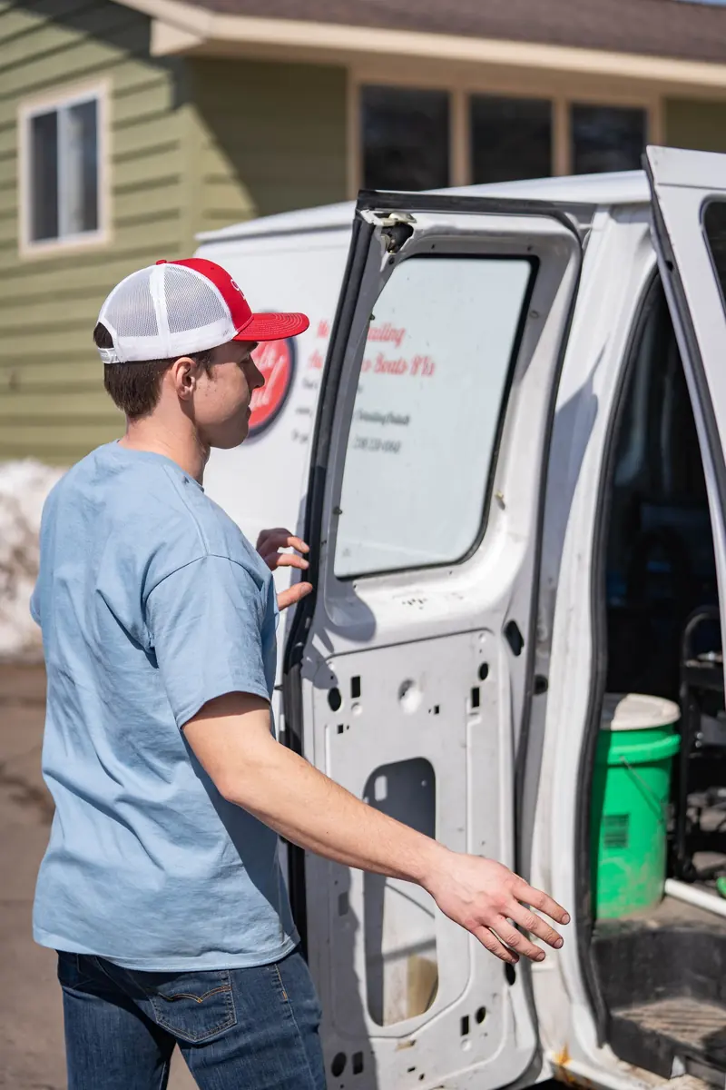 Working the door of a van in a driveway